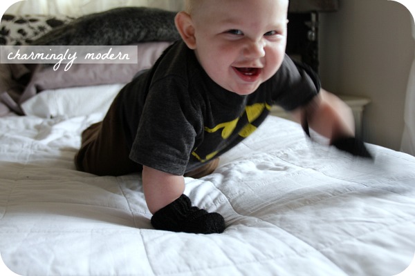 baby in black knitted mittens