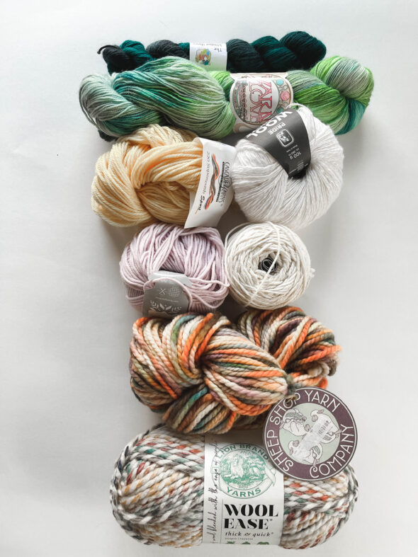 A collection of yarn hanks and skeins showing the different weights of yarn available.