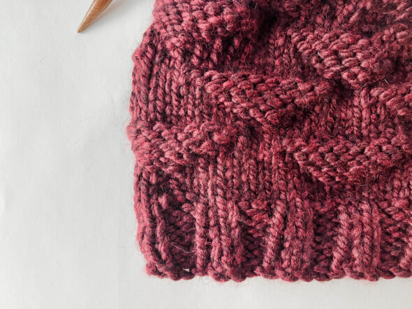 Closeup of knit rib stitch and upside triangle knitting stitch pattern