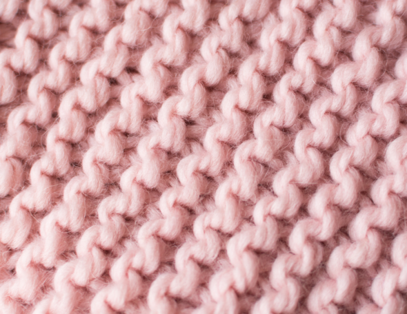 Closeup of the back of knitted fabric, showing the purl stitch